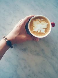 Midsection of woman holding coffee cup