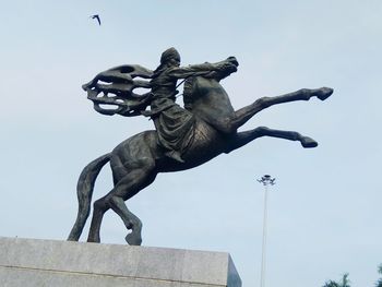 Low angle view of statue against sky