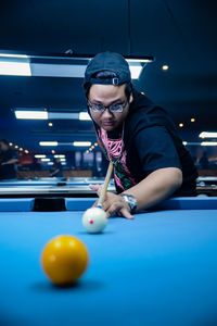 Portrait of man playing pool