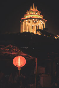 Low angle view of illuminated building against sky at night