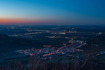 High angle view of illuminated buildings in city at night