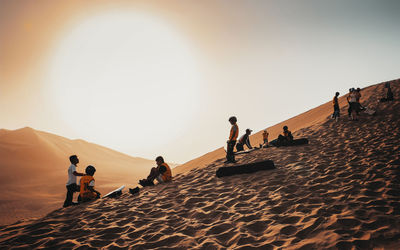 People on beach against clear sky