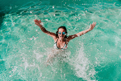 High angle view of woman swimming in pool