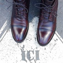 Close-up of shoes on tiled floor