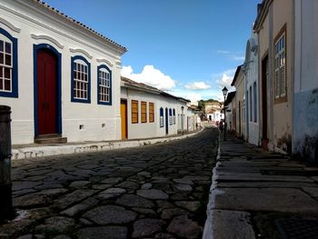 Empty alley amidst houses in town