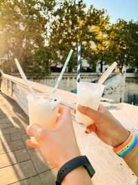 Cropped hand of men holding ice cream