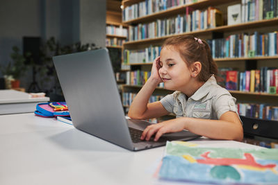 Young woman using laptop at home