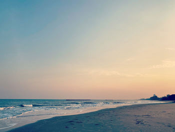 Scenic view of beach against sky during sunset