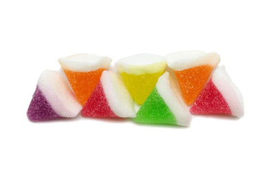 Close-up of multi colored candies against white background