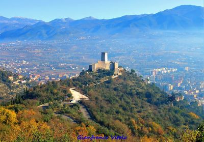 High angle view of buildings and mountains against sky