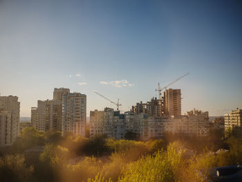 Buildings in city against clear sky