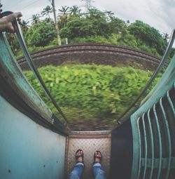 Low section of man standing in train
