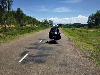 Man riding motorcycle on road