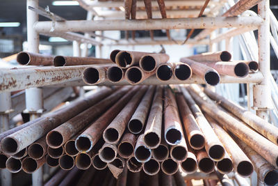 Close-up of rusty pipes on shelf