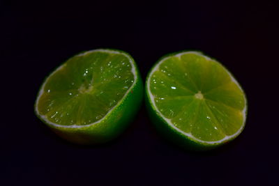 Close-up of green fruits against black background