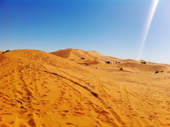 Scenic view of sand dunes at desert against sky 