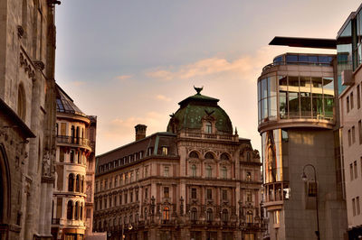 Low angle view of buildings against sky during sunset