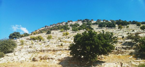 Scenic view of mountains against clear blue sky