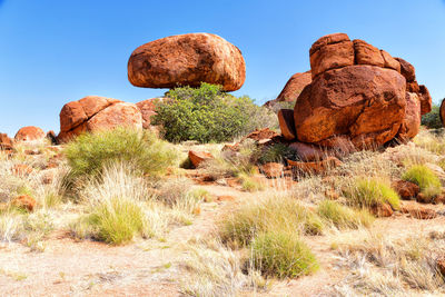 Rock formations on landscape against sky