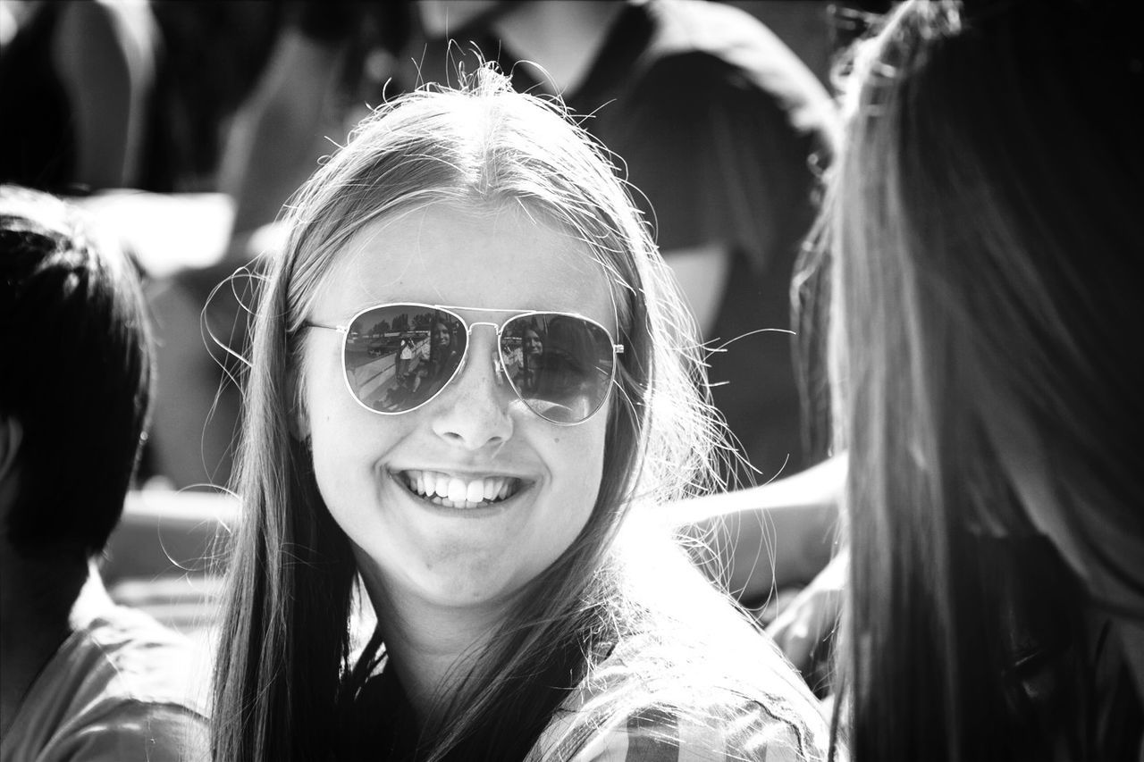 lifestyles, leisure activity, person, headshot, portrait, head and shoulders, looking at camera, young adult, focus on foreground, smiling, casual clothing, young women, childhood, sunglasses, front view, girls, elementary age, happiness