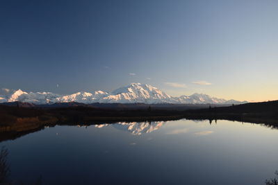 Scenic view of lake and mountains against sky during winter