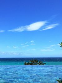 Scenic view of sea against blue sky