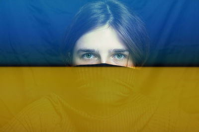 War between russia and ukraine. young woman with sad sight looking at camera. art portrait. mental 