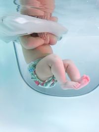 Low section of baby in bathtub