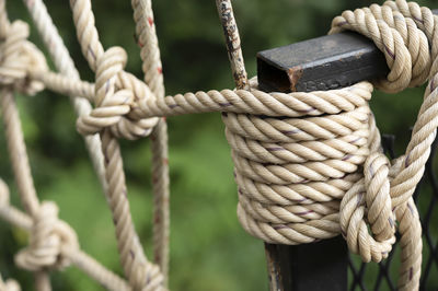 Close-up of rope tied on wooden post