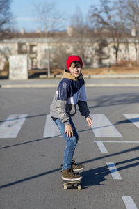 Full length boy skateboarding outdoors