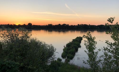 Scenic view of lake against sky during sunset