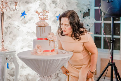 Woman looking away while standing on table