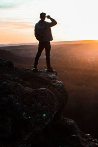 Watching the sunset from the edge of a cliff