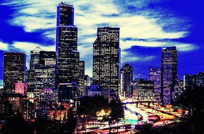 Illuminated cityscape against sky