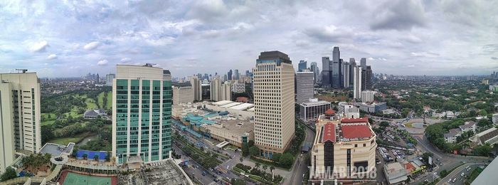 High angle view of modern buildings in city against sky