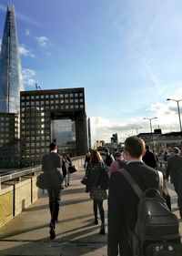 People walking on street against buildings in city