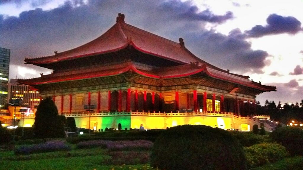 architecture, built structure, building exterior, sky, temple - building, cloud - sky, religion, place of worship, spirituality, tree, illuminated, famous place, travel destinations, low angle view, cultures, cloud, facade, tradition, cloudy