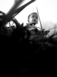 Portrait of boy holding plant