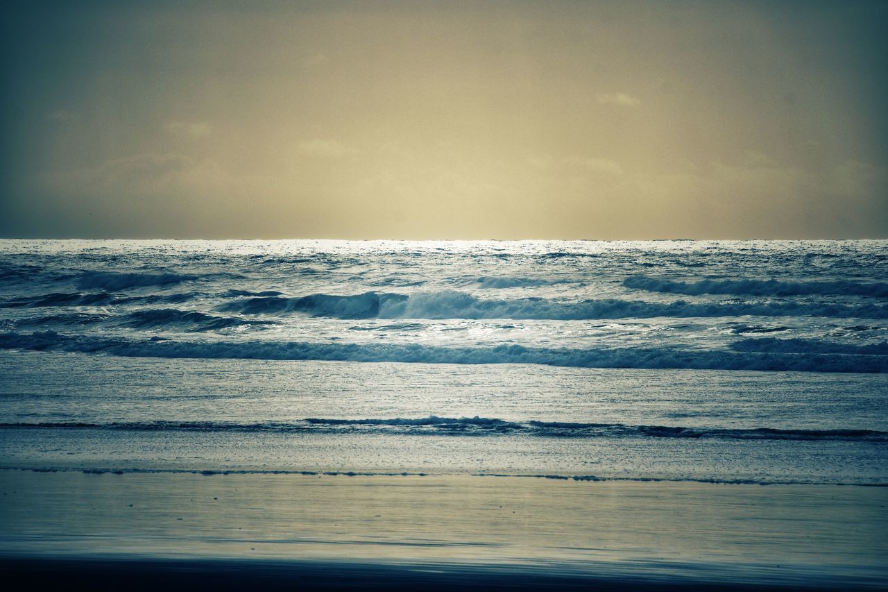 SCENIC VIEW OF BEACH AGAINST SKY DURING SUNRISE