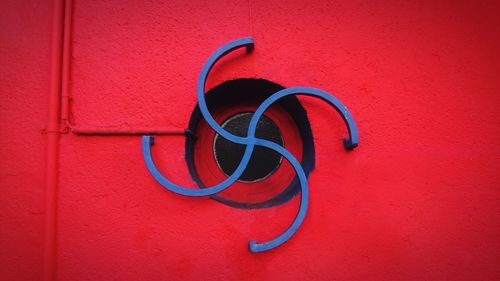 Close-up of heart shape on red wall