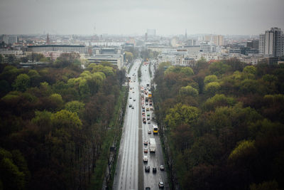 High angle view of vehicles on road along trees