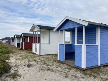 Houses on beach against sky