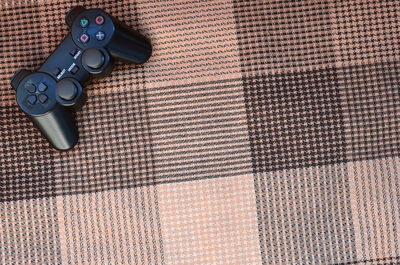 High angle view of joystick on towel