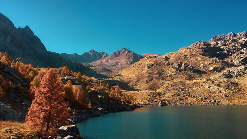 Scenic view of mountains against clear blue sky