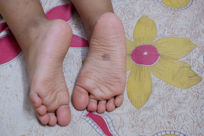 Low section of baby feet on bed