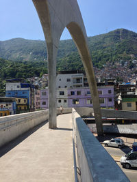 Bridge by buildings in city against clear sky