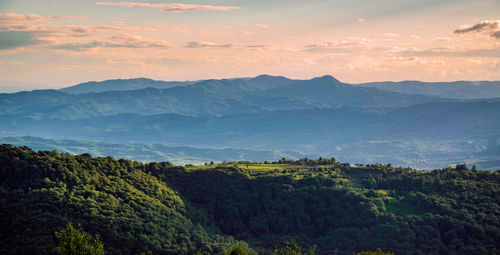 Scenic view of mountains against cloudy sky