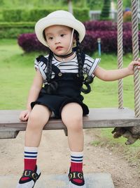 Portrait of cute girl sitting outdoors