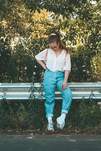 Full length of girl standing against plants