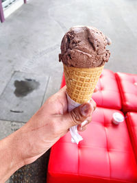 Close-up of hand holding ice cream cone